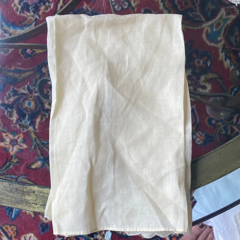 One fine linen embroidered tea towels. A muted butter yellow Vintage 1960s
